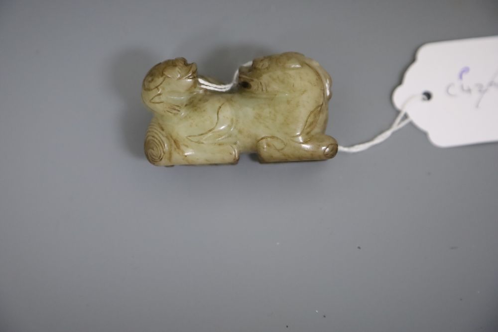 A Chinese pale celadon and brown jade group of a lion dog and cub, 18th / 19th century, L.6.3cm